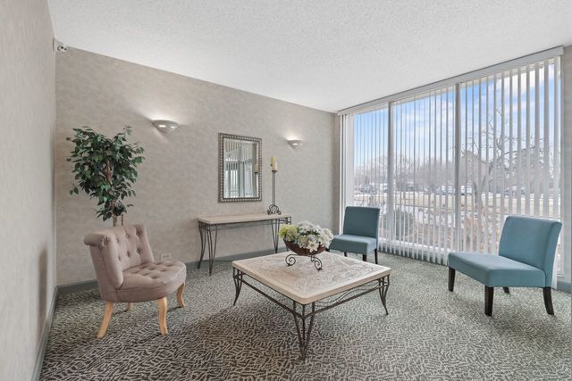 8809 West Golf Road, Unit 2B Niles, IL 60714 - Photo 16 of 17 a living room with furniture and a potted plant
