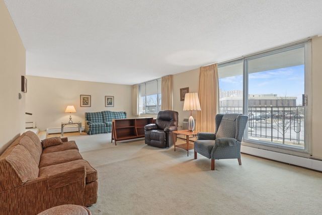 8809 West Golf Road, Unit 2B Niles, IL 60714 - Photo 3 of 17 a living room with furniture and a large window