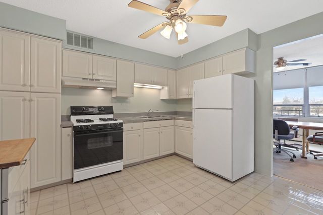 8809 West Golf Road, Unit 2B Niles, IL 60714 - Photo 5 of 17 a kitchen with cabinets stainless steel appliances and a counter top space