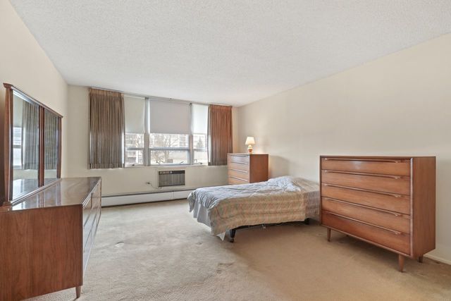 8809 West Golf Road, Unit 2B Niles, IL 60714 - Photo 6 of 17 a bedroom with a bed and a window