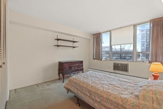 8809 West Golf Road, Unit 2B Niles, IL 60714 - Photo 8 of 17 a bedroom with a bed and window
