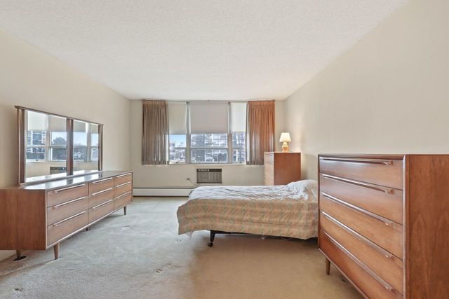 8809 West Golf Road, Unit 2B Niles, IL 60714 - Photo 10 of 17 a bedroom with a bed and large window