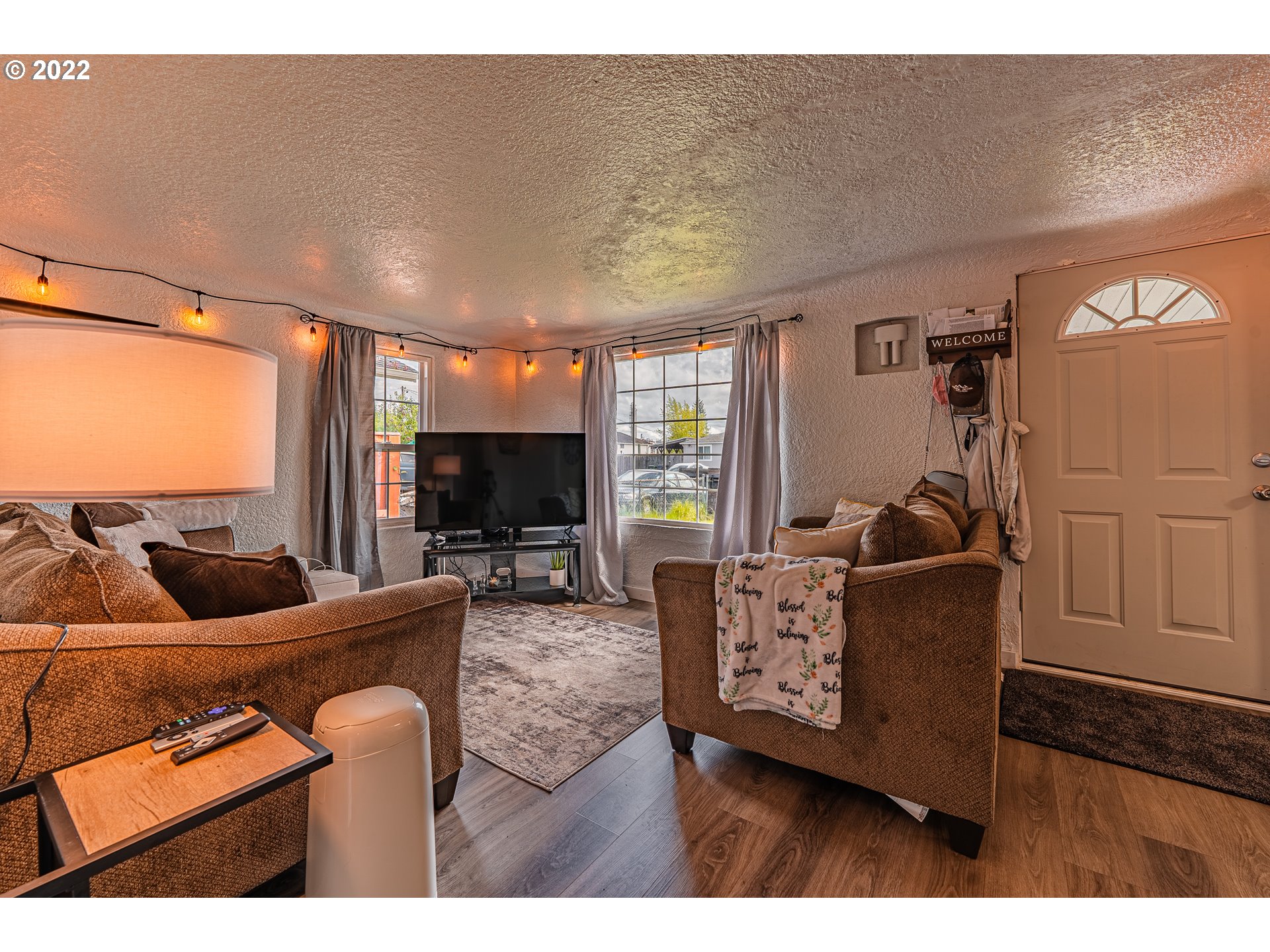 2740 D Street Springfield, OR 97477 - Photo 5 of 21 a living room with furniture a flat screen tv and a large window