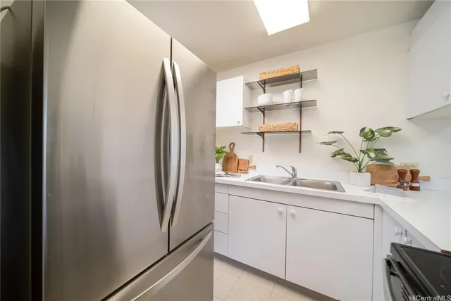 a kitchen with cabinets and stainless steel appliances