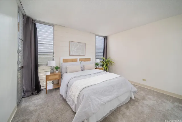 a bedroom with a bed and a painting on the wall