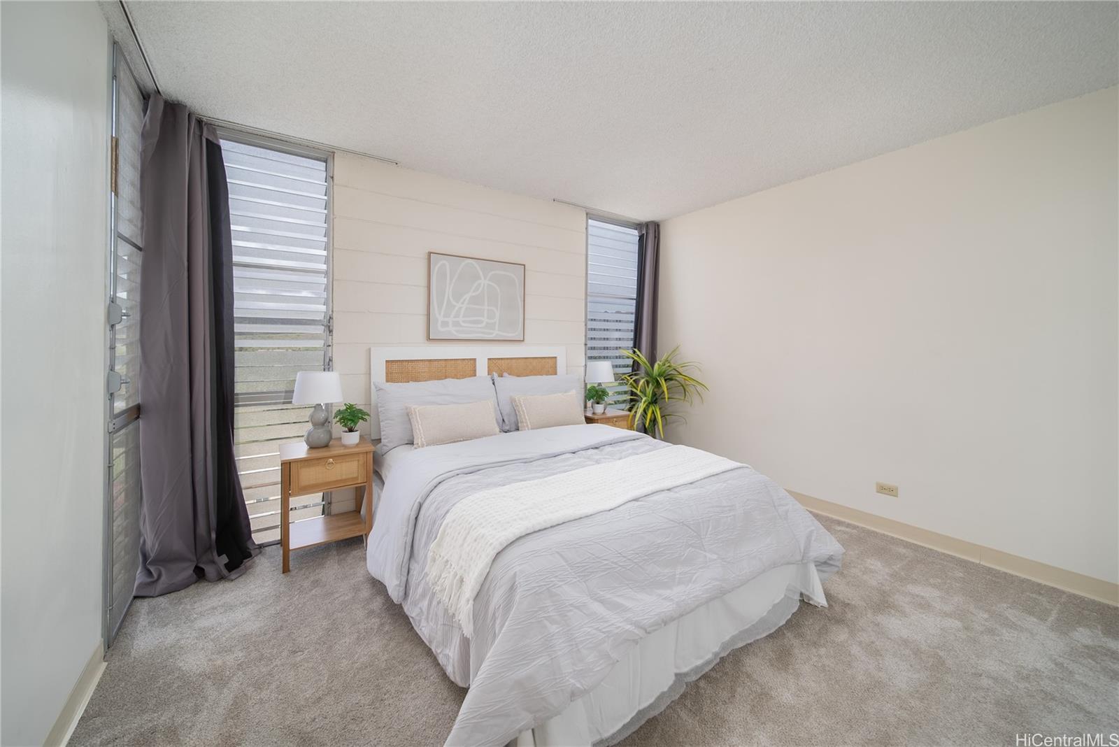 3030 Ala Ilima Street, Unit 907 Honolulu, HI 96818 - Photo 12 of 25 a bedroom with a bed and a painting on the wall