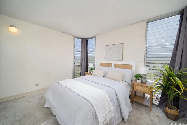 a bedroom with a bed potted plant and a window