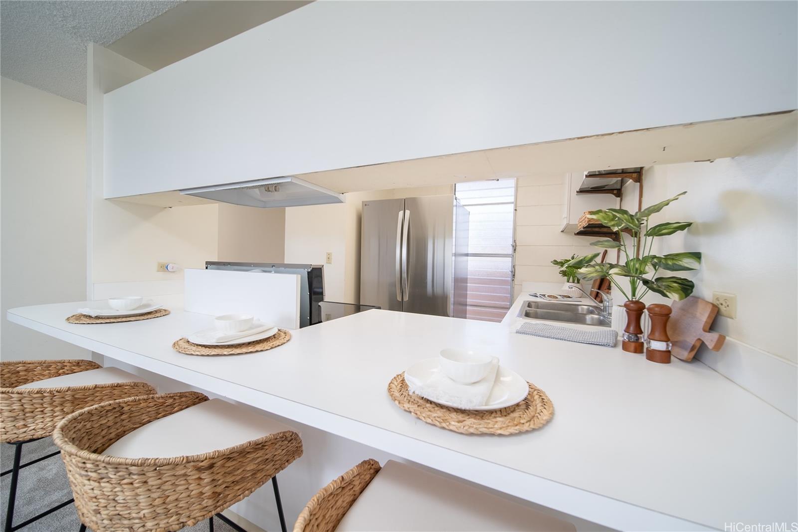 3030 Ala Ilima Street, Unit 907 Honolulu, HI 96818 - Photo 8 of 25 a dining room with furniture and a table