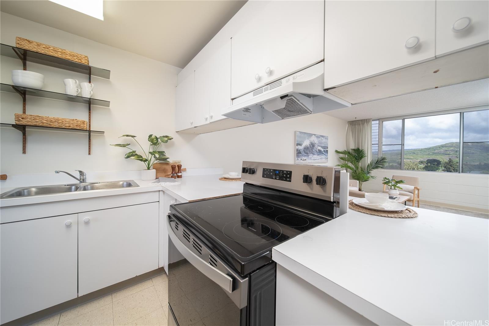 3030 Ala Ilima Street, Unit 907 Honolulu, HI 96818 - Photo 10 of 25 a kitchen with a stove a sink and wooden floor