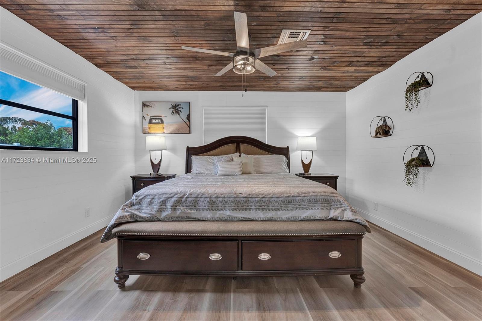 1111 Brown Road Lake Worth, FL 33462 - Photo 11 of 63 a bedroom with a bed and wooden floor