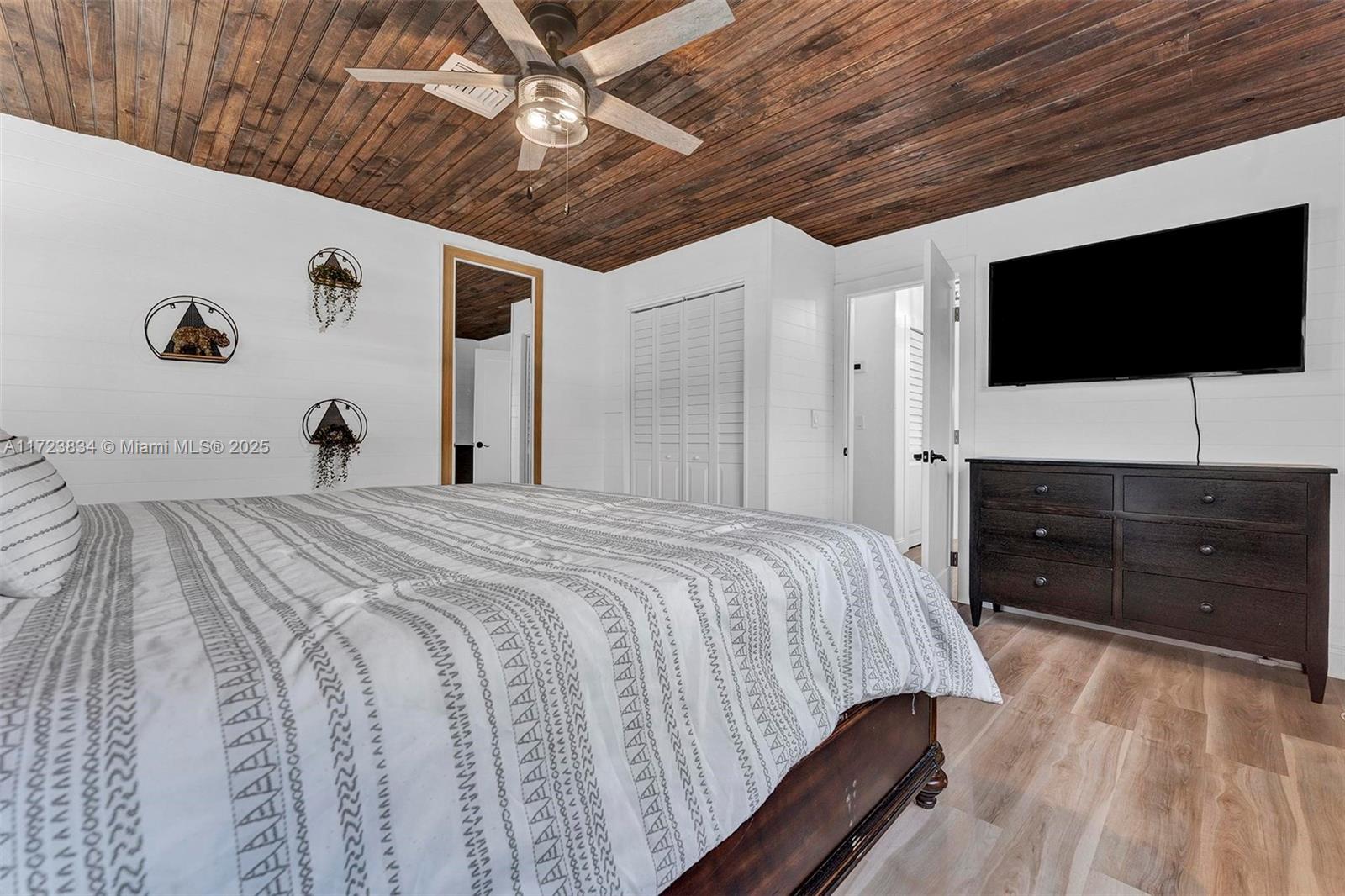 1111 Brown Road Lake Worth, FL 33462 - Photo 12 of 63 a bedroom with a bed and a flat screen tv