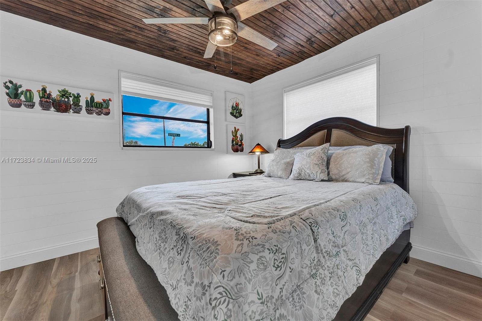 1111 Brown Road Lake Worth, FL 33462 - Photo 15 of 63 a bedroom with a bed and a painting on the wall