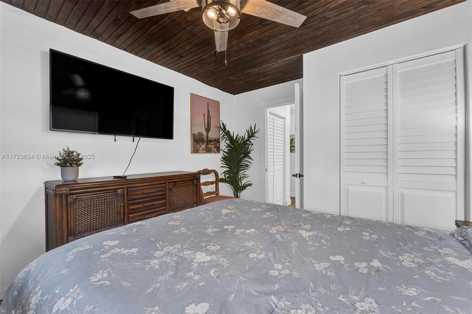 1111 Brown Road Lake Worth, FL 33462 - Photo 18 of 63 a bedroom with a bed and a flat screen tv