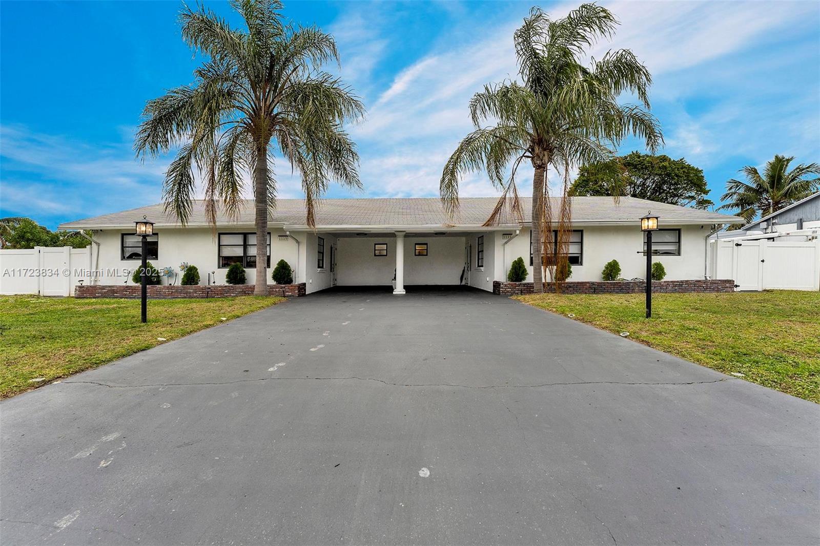 1111 Brown Road Lake Worth, FL 33462 - Photo 2 of 63 a couple of palm trees in front of house