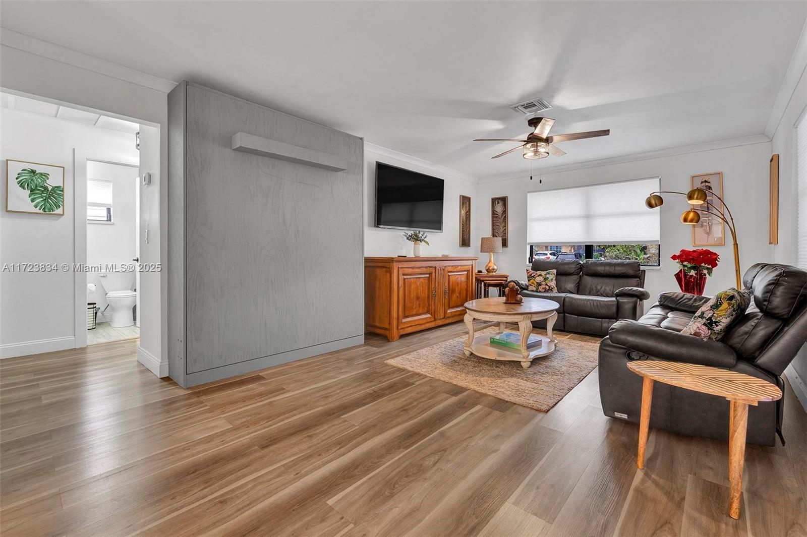 1111 Brown Road Lake Worth, FL 33462 - Photo 33 of 63 a living room with furniture and a flat screen tv