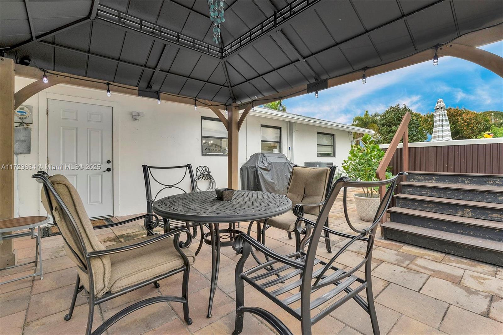 1111 Brown Road Lake Worth, FL 33462 - Photo 38 of 63 a view of a patio with table and chairs under an umbrella