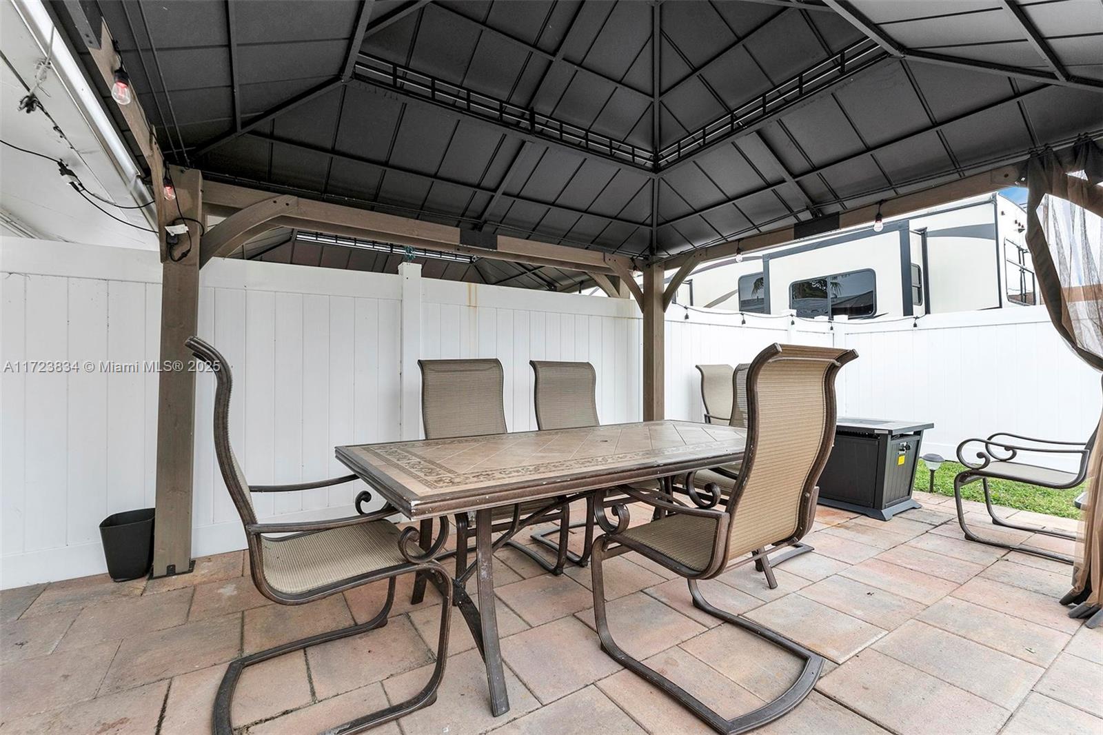 1111 Brown Road Lake Worth, FL 33462 - Photo 42 of 63 a roof deck with table and chairs a barbeque