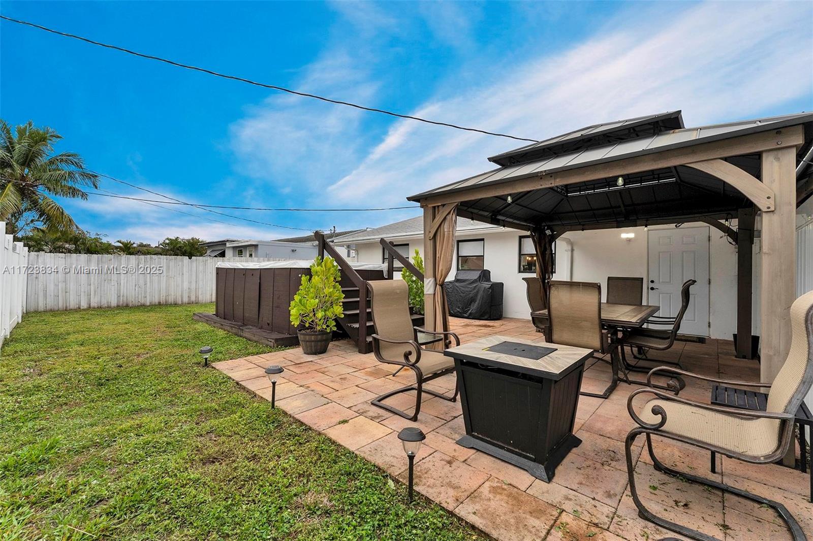 1111 Brown Road Lake Worth, FL 33462 - Photo 45 of 63 a view of a patio with table and chairs with wooden floor
