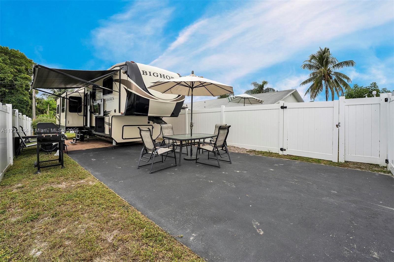 1111 Brown Road Lake Worth, FL 33462 - Photo 49 of 63 a view of a white house with a swimming pool and sitting area