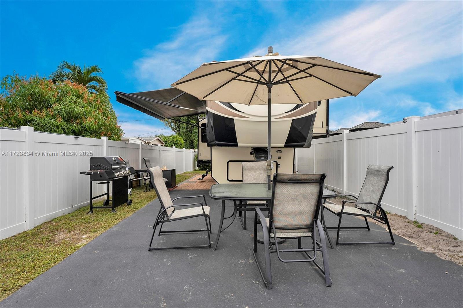 1111 Brown Road Lake Worth, FL 33462 - Photo 50 of 63 a view of a patio with a table and chairs under an umbrella