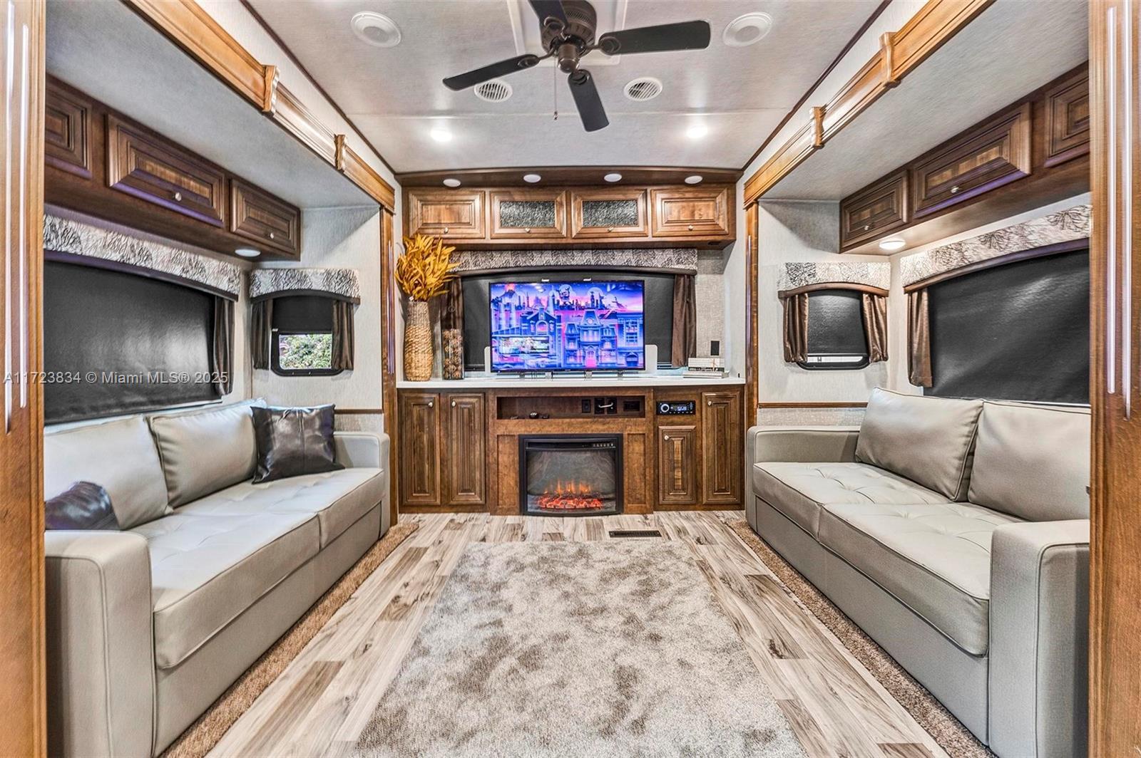 1111 Brown Road Lake Worth, FL 33462 - Photo 55 of 63 a living room with furniture a fireplace and a ceiling fan