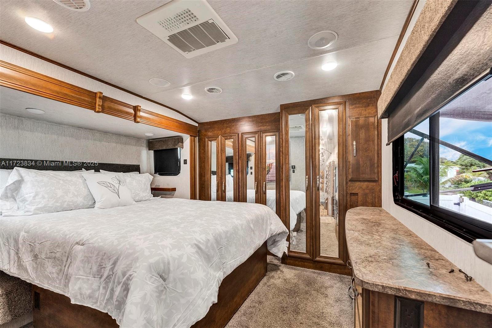 1111 Brown Road Lake Worth, FL 33462 - Photo 58 of 63 a large bedroom with a large bed and large windows