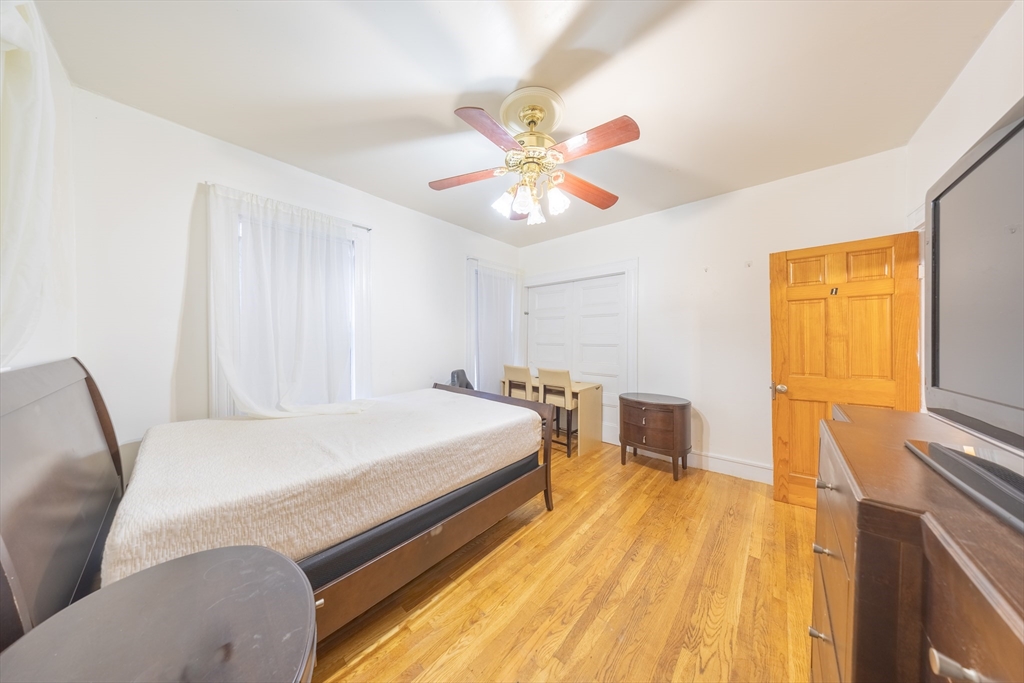 31 Seattle Street, Unit 1 Boston, MA 02134 - Photo 11 of 31 a bedroom with a bed and a chandelier
