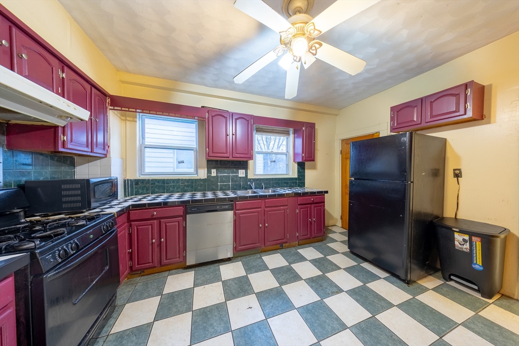 31 Seattle Street, Unit 1 Boston, MA 02134 - Photo 12 of 31 a kitchen with stainless steel appliances granite countertop a refrigerator and a sink