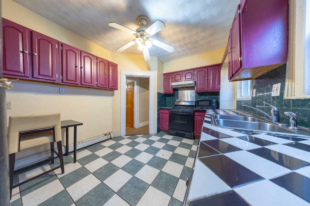 31 Seattle Street, Unit 1 Boston, MA 02134 - Photo 15 of 31 a kitchen with stainless steel appliances granite countertop a sink and a stove