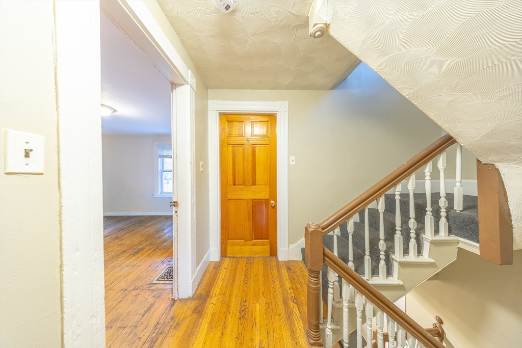 31 Seattle Street, Unit 1 Boston, MA 02134 - Photo 21 of 31 a view of a hallway with wooden floor and staircase