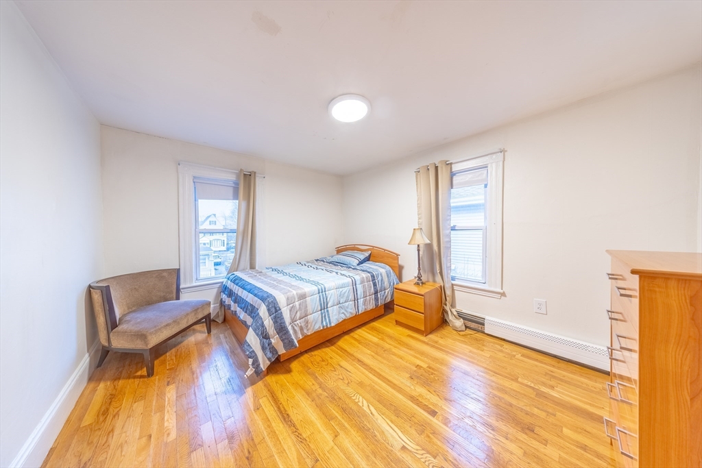 31 Seattle Street, Unit 1 Boston, MA 02134 - Photo 23 of 31 a bedroom with a bed and wooden floor
