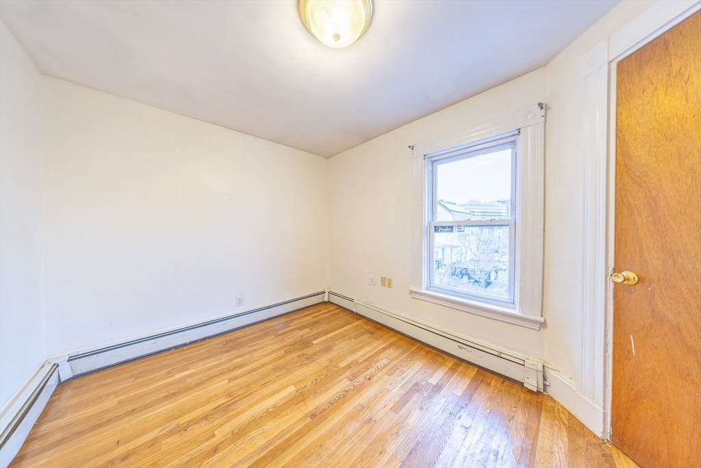31 Seattle Street, Unit 1 Boston, MA 02134 - Photo 25 of 31 a view of a room with wooden floor and windows