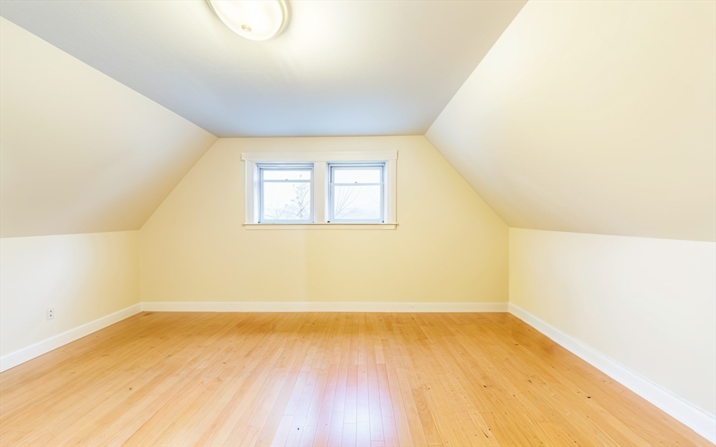 31 Seattle Street, Unit 1 Boston, MA 02134 - Photo 31 of 31 an empty room with wooden floor and windows