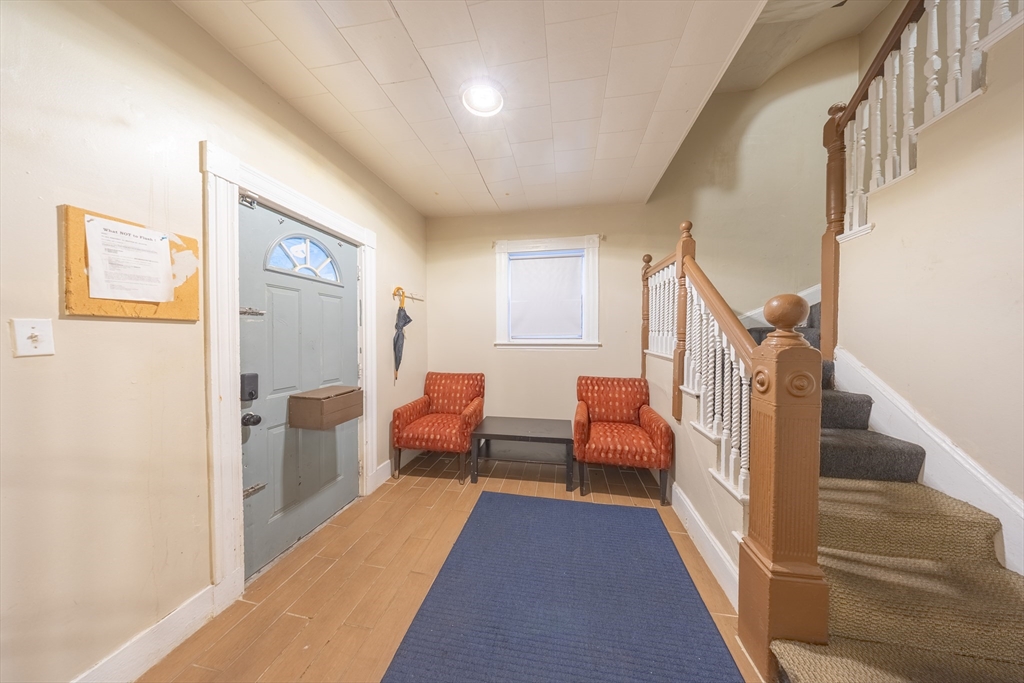 31 Seattle Street, Unit 1 Boston, MA 02134 - Photo 6 of 31 a view of a hallway with couches and dining table