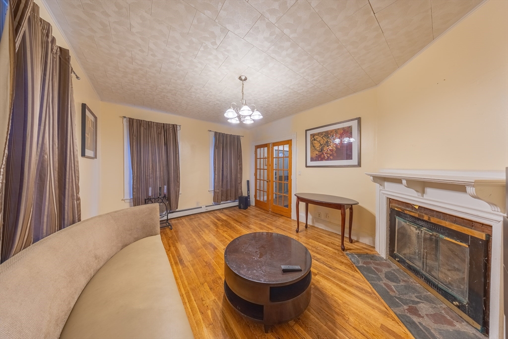 31 Seattle Street, Unit 1 Boston, MA 02134 - Photo 8 of 31 a spacious bedroom with a bed and a fireplace