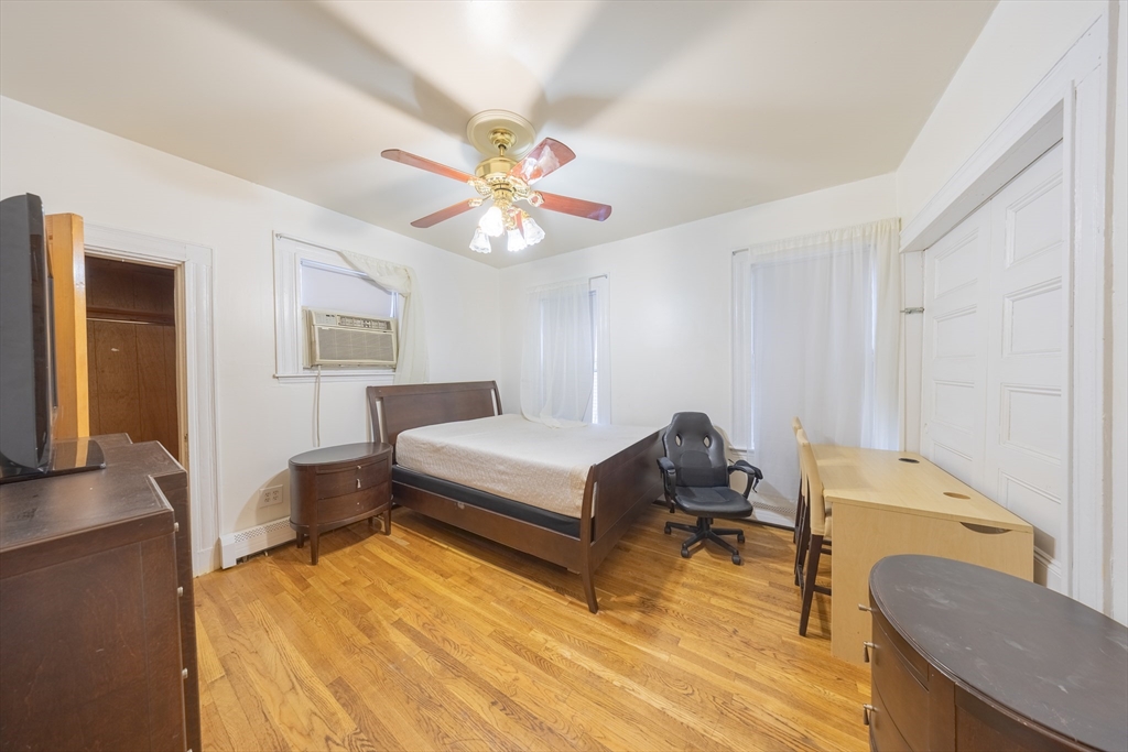 31 Seattle Street, Unit 1 Boston, MA 02134 - Photo 10 of 31 a bedroom with a bed and a chandelier