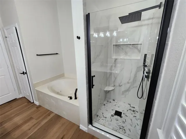 a bathroom with a bathtub and a shower
