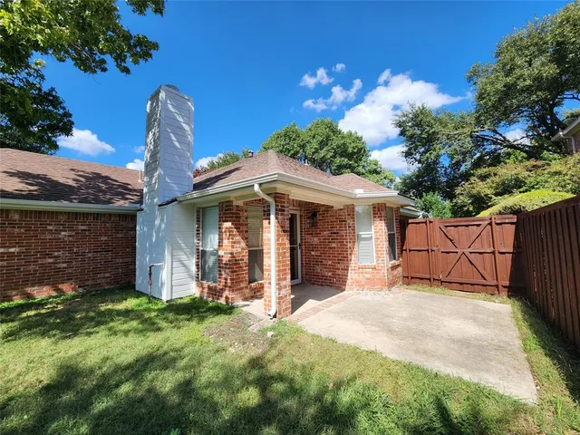 a view of a house with a yard and flower plants