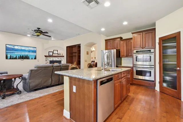 a kitchen with stainless steel appliances granite countertop a stove and a refrigerator