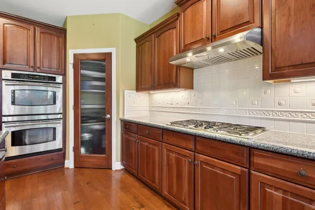 a kitchen with granite countertop stainless steel appliances and cabinets