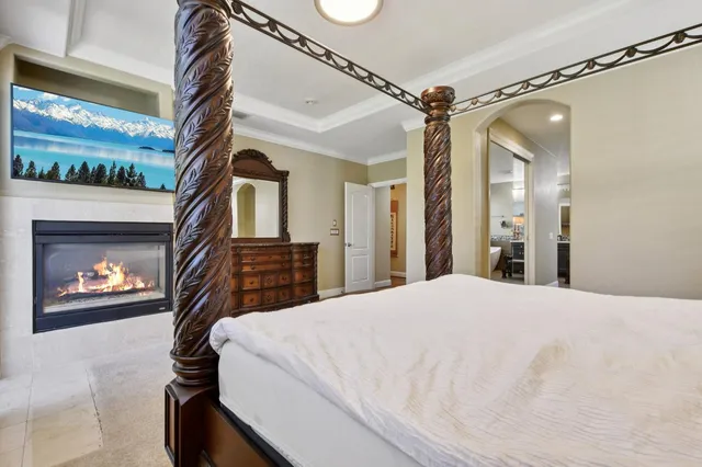 a bedroom with a bed and a mirror on the dresser