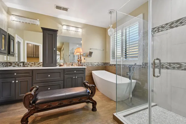 a bathroom with a sink a light fixture and a mirror