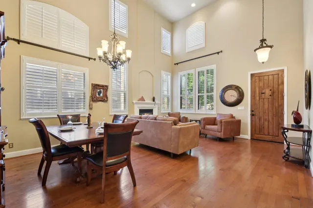 a living room with fireplace furniture and a large window