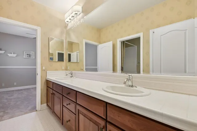 a bathroom with a sink double vanity and a mirror
