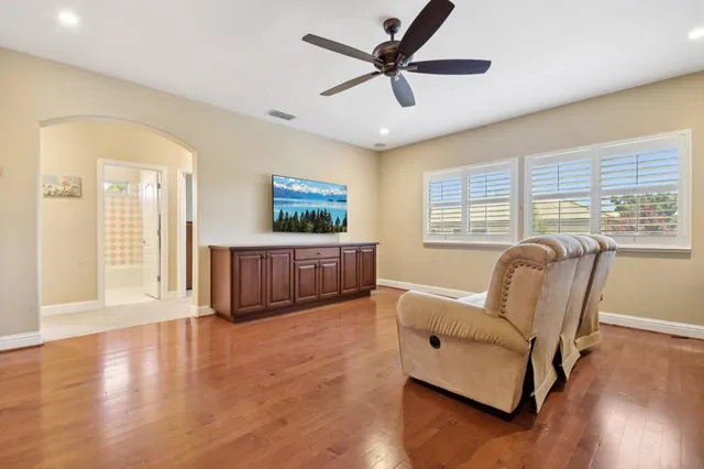 a living room with furniture window and wooden floor