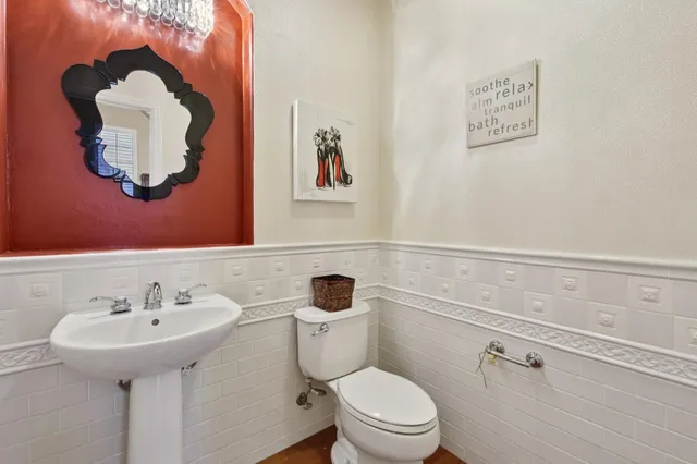a bathroom with a sink mirror and toilet