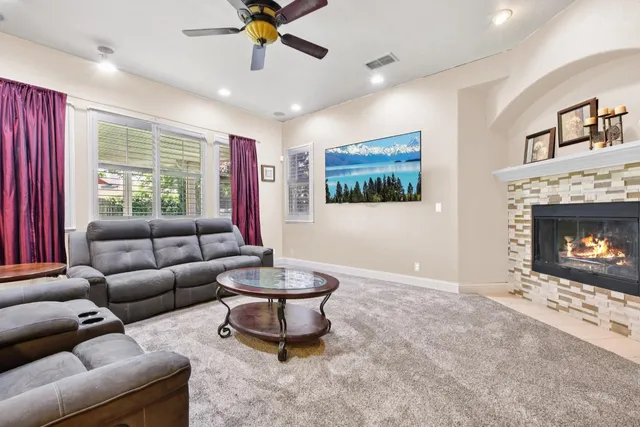 a living room with furniture a fireplace and a flat screen tv