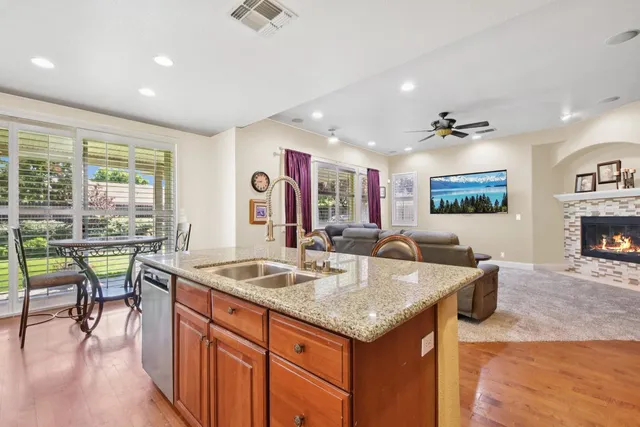 a open kitchen with stainless steel appliances granite countertop sink stove and table