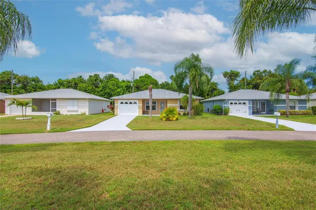 a view of pool with umbrella and yard