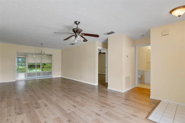a view of room with wooden floor and ceiling fan
